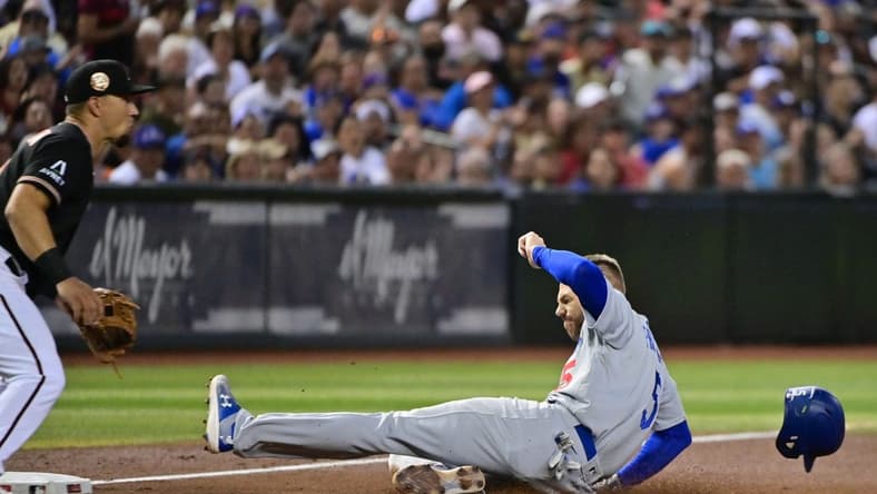 Aug 9, 2023; Phoenix, Arizona, USA;  Los Angeles Dodgers first baseman Freddie Freeman (5) slides into third base in the fourth inning at Chase Field. Mandatory Credit: Matt Kartozian-USA TODAY Sports