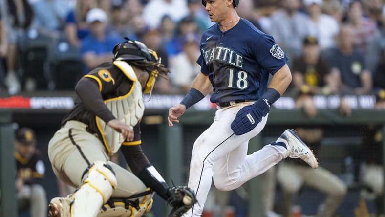 Aug 9, 2023; Seattle, Washington, USA; Seattle Mariners left fielder Cade Marlowe (18) scores a run against San Diego Padres catcher Luis Campusano (12) during the third inning at T-Mobile Park. Mandatory Credit: Stephen Brashear-USA TODAY Sports