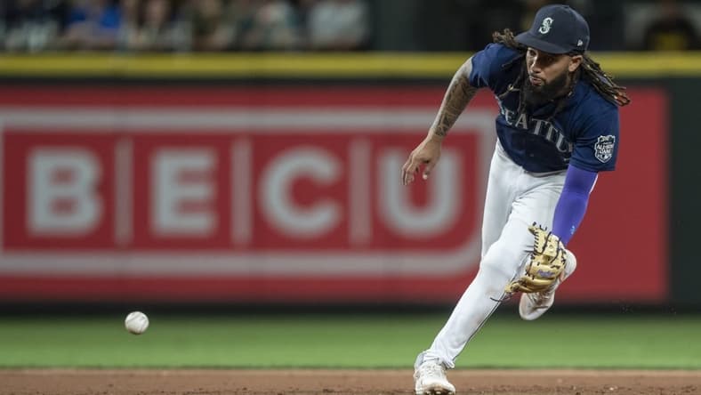 Aug 9, 2023; Seattle, Washington, USA; Seattle Mariners shortstop J.P. Crawford (3) fields a ground ball during the eighth inning against the San Diego Padres at T-Mobile Park. Mandatory Credit: Stephen Brashear-USA TODAY Sports
