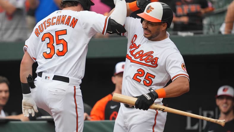 Aug 10, 2023; Baltimore, Maryland, USA; Baltimore Orioles designated hitter Adley Rutschman (35) is greeted by outfielder Anthony Santander (25) following his solo home run in the first inning against the Houston Astros at Oriole Park at Camden Yards. Mandatory Credit: Mitch Stringer-USA TODAY Sports