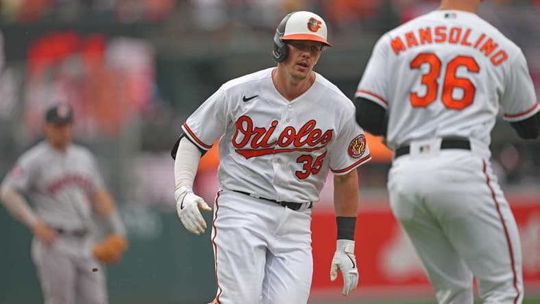 Aug 10, 2023; Baltimore, Maryland, USA; Baltimore Orioles designated hitter Adley Rutschman (35) is greeted by coach Tony Mansolino (36) following his solo home run in the first inning against the Houston Astros at Oriole Park at Camden Yards. Mandatory Credit: Mitch Stringer-USA TODAY Sports