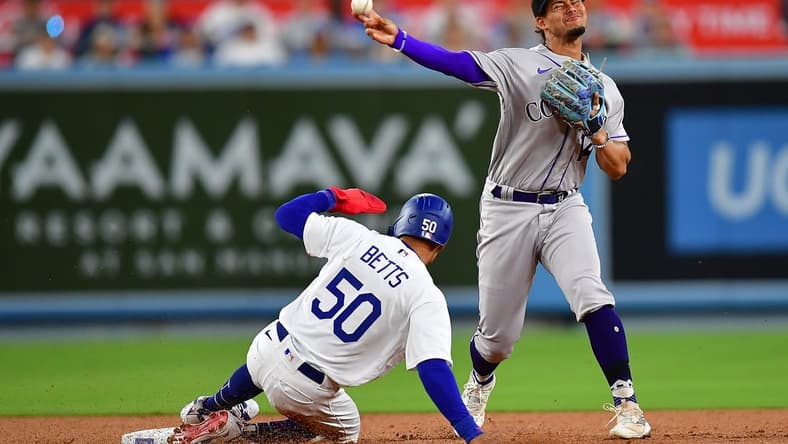 Aug 10, 2023; Los Angeles, California, USA; Los Angeles Dodgers right fielder Mookie Betts (50) is out at second as Colorado Rockies shortstop Ezequiel Tovar (14) is late on the throw to first during the third inning at Dodger Stadium. Mandatory Credit: Gary A. Vasquez-USA TODAY Sports