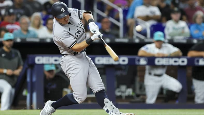 Aug 11, 2023; Miami, Florida, USA; New York Yankees shortstop Anthony Volpe (11) hits a three-run home run against the Miami Marlins during the second inning at loanDepot Park. Mandatory Credit: Sam Navarro-USA TODAY Sports