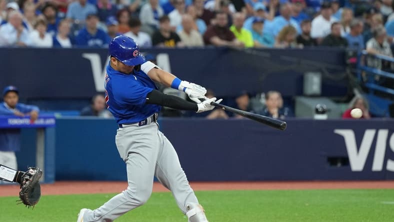 Aug 11, 2023; Toronto, Ontario, CAN; Chicago Cubs right fielder Seiya Suzuki (27) hits a two RBI double against the Toronto Blue Jays during the fourth inning at Rogers Centre. Mandatory Credit: Nick Turchiaro-USA TODAY Sports