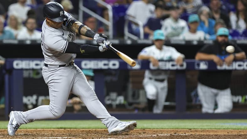 Aug 11, 2023; Miami, Florida, USA; New York Yankees second baseman Gleyber Torres (25) hits a double against the Miami Marlins during the sixth inning at loanDepot Park. Mandatory Credit: Sam Navarro-USA TODAY Sports