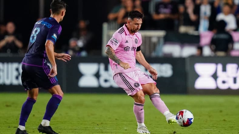 Aug 11, 2023; Fort Lauderdale, FL, USA; Inter Miami CF forward Lionel Messi (10) plays the ball as Charlotte FC midfielder Ashley Westwood (8) defends in the first half at DRV PNK Stadium. Mandatory Credit: John David Mercer-USA TODAY Sports