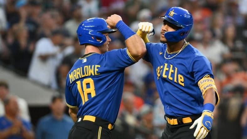 Aug 11, 2023; Seattle, Washington, USA; Seattle Mariners left fielder Cade Marlowe (18) and center fielder Julio Rodriguez (44) celebrate after Rodriguez hit a 3-run home run against the Baltimore Orioles during the fourth inning at T-Mobile Park. Mandatory Credit: Steven Bisig-USA TODAY Sports