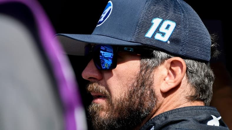 NASCAR Cup Series driver Martin Truex Jr. (19) stands by his car Saturday, Aug. 12, 2023, during practice for the NASCAR Cup Series Verizon 200 at Indianapolis Motor Speedway.