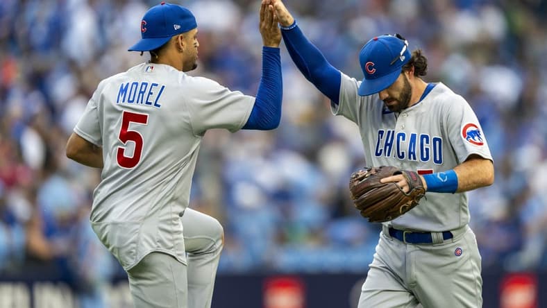 Aug 12, 2023; Toronto, Ontario, CAN; Chicago Cubs second baseman Christopher Morel (5) celebrates with teammate shortstop Dansby Swanson (7) after defeating the Toronto Blue Jays at Rogers Centre. Mandatory Credit: Kevin Sousa-USA TODAY Sports