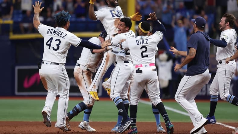 Aug 12, 2023; St. Petersburg, Florida, USA;  Tampa Bay Rays left fielder Randy Arozarena (56) is congratulated after he hit a walk off RBI single against the Cleveland Guardians during the ninth inning at Tropicana Field. Mandatory Credit: Kim Klement Neitzel-USA TODAY Sports