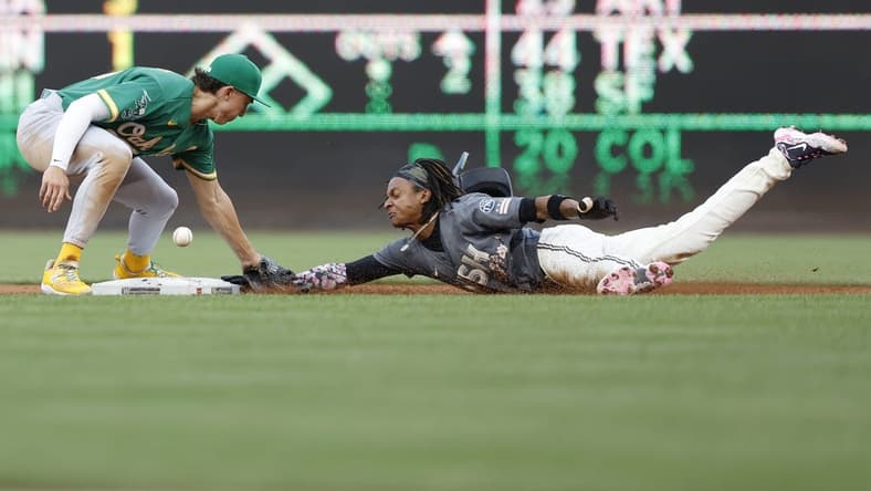 Aug 12, 2023; Washington, District of Columbia, USA; Washington Nationals shortstop CJ Abrams (5) steals second base ahead of an attempted tag by Oakland Athletics second baseman Zack Gelof (20) during the first inning at Nationals Park. Mandatory Credit: Geoff Burke-USA TODAY Sports