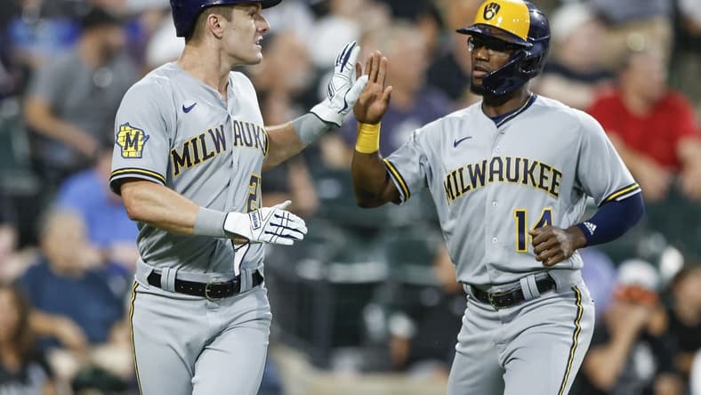 Aug 12, 2023; Chicago, Illinois, USA; Milwaukee Brewers second baseman Andruw Monasterio (14) celebrates with left fielder Mark Canha (21) after they both scored against the Chicago White Sox during the seventh inning at Guaranteed Rate Field. Mandatory Credit: Kamil Krzaczynski-USA TODAY Sports