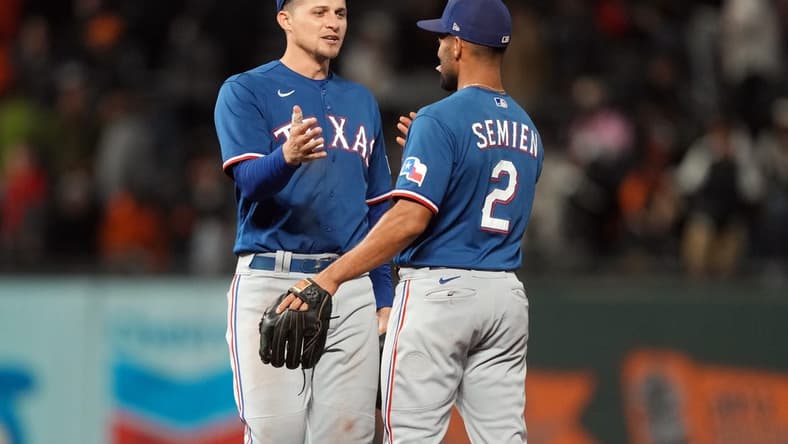 Aug 12, 2023; San Francisco, California, USA; Texas Rangers shortstop Corey Seager (left) celebrates with second baseman Marcus Semien (2) after defeating the San Francisco Giants at Oracle Park. Mandatory Credit: Darren Yamashita-USA TODAY Sports