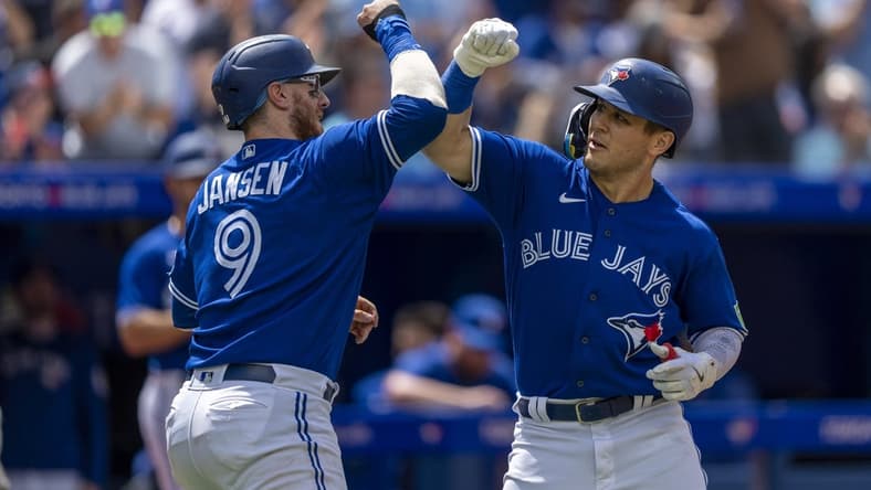 Aug 13, 2023; Toronto, Ontario, CAN; Toronto Blue Jays left fielder Daulton Varsho (25) celebrates hitting a home run against the Chicago Cubs with teammate catcher Danny Jansen (9) during the second inning at Rogers Centre. Mandatory Credit: Kevin Sousa-USA TODAY Sports