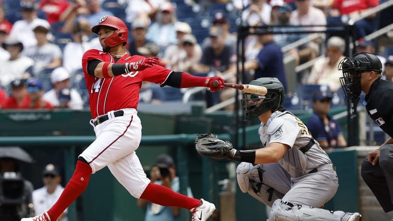Aug 13, 2023; Washington, District of Columbia, USA; Washington Nationals shortstop Ildemaro Vargas (14) hits a single against the Oakland Athletics during the third inning at Nationals Park. Mandatory Credit: Geoff Burke-USA TODAY Sports