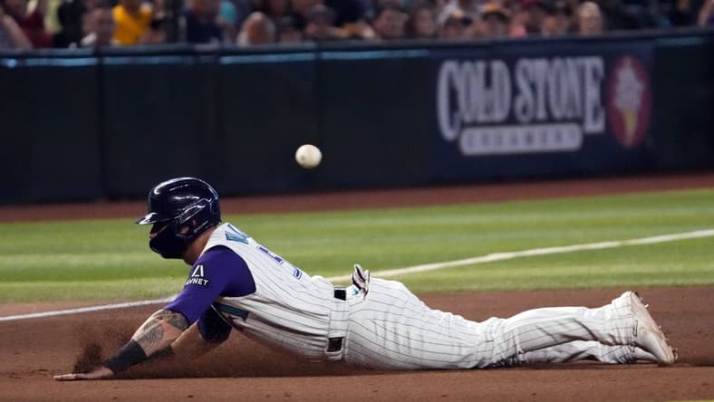 Aug 13, 2023; Phoenix, Arizona, USA; Arizona Diamondbacks first baseman Christian Walker (53) slides into third base against the San Diego Padres during the eighth inning at Chase Field. Mandatory Credit: Joe Camporeale-USA TODAY Sports