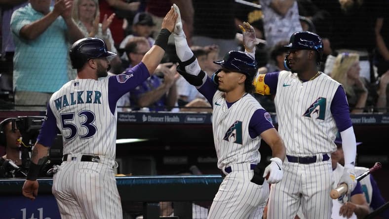 Aug 13, 2023; Phoenix, Arizona, USA; Arizona Diamondbacks first baseman Christian Walker (53) and Arizona Diamondbacks center fielder Alek Thomas (5) an Arizona Diamondbacks shortstop Geraldo Perdomo (2) celebrate during the eighth inning against the San Diego Padres at Chase Field. Mandatory Credit: Joe Camporeale-USA TODAY Sports