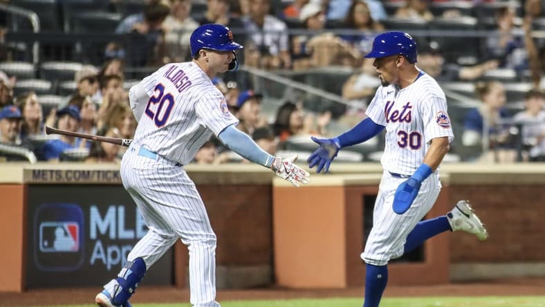 Aug 13, 2023; New York City, New York, USA; New York Mets center fielder Rafael Ortega (30) is greeted by first baseman Pete Alonso (20) after scoring in the third inning against the Atlanta Braves at Citi Field. Mandatory Credit: Wendell Cruz-USA TODAY Sports