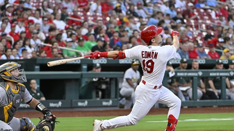 Aug 14, 2023; St. Louis, Missouri, USA;  St. Louis Cardinals shortstop Tommy Edman (19) hits one run single against the Oakland Athletics during the second inning at Busch Stadium. Mandatory Credit: Jeff Curry-USA TODAY Sports