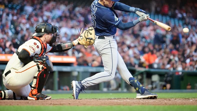 Aug 14, 2023; San Francisco, California, USA; Tampa Bay Rays infielder Curtis Mead (25) hits an infield single against the San Francisco Giants during the fifth inning at Oracle Park. Mandatory Credit: Robert Edwards-USA TODAY Sports