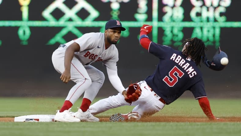 Aug 15, 2023; Washington, District of Columbia, USA; Washington Nationals shortstop CJ Abrams (5) steals second base ahead of a tag by Boston Red Sox shortstop Pablo Reyes (19) during the first inning at Nationals Park. Mandatory Credit: Geoff Burke-USA TODAY Sports