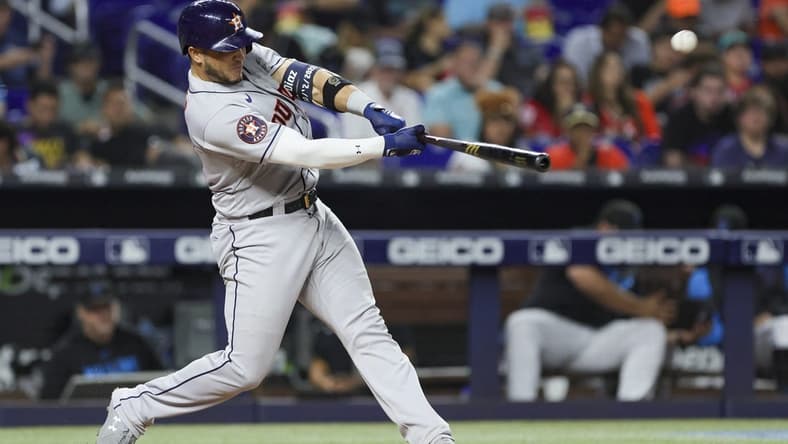 Aug 15, 2023; Miami, Florida, USA; Houston Astros catcher Yainer Diaz (21) hits a two-run home run against the Miami Marlins during the fourth inning at loanDepot Park. Mandatory Credit: Sam Navarro-USA TODAY Sports