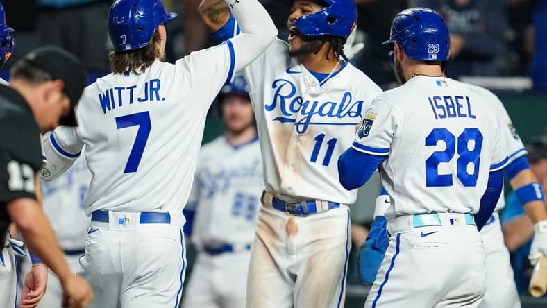 Aug 15, 2023; Kansas City, Missouri, USA; Kansas City Royals shortstop Bobby Witt Jr. (7) is congratulated by third baseman Maikel Garcia (11) and center fielder Kyle Isbel (28) after hitting a grand slam during the fifth inning against the Seattle Mariners at Kauffman Stadium. Mandatory Credit: Jay Biggerstaff-USA TODAY Sports