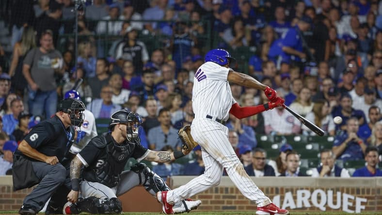 Aug 15, 2023; Chicago, Illinois, USA; Chicago Cubs third baseman Jeimer Candelario (9) singles against the Chicago White Sox during the sixth inning at Wrigley Field. Mandatory Credit: Kamil Krzaczynski-USA TODAY Sports
