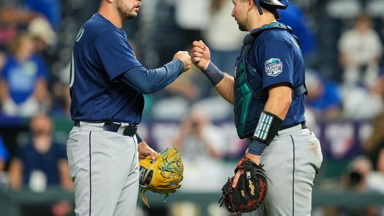 Aug 15, 2023; Kansas City, Missouri, USA; Seattle Mariners relief pitcher Tayler Saucedo (60) celebrates with catcher Cal Raleigh (29) after defeating the Kansas City Royals at Kauffman Stadium. Mandatory Credit: Jay Biggerstaff-USA TODAY Sports