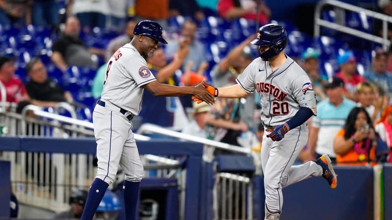 Aug 16, 2023; Miami, Florida, USA; Houston Astros center fielder Chas McCormick (20) celebrates with Houston Astros third base coach Gary Pettis (8) after hitting a home run against the Miami Marlins during the first inning at loanDepot Park. Mandatory Credit: Rich Storry-USA TODAY Sports