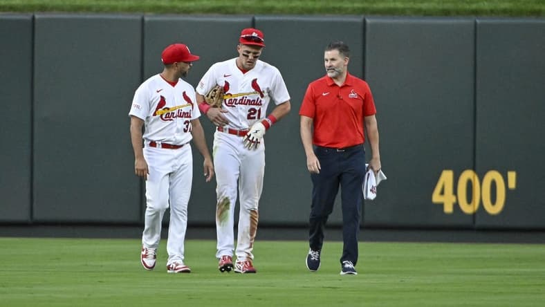 Aug 16, 2023; St. Louis, Missouri, USA;  St. Louis Cardinals center fielder Lars Nootbaar (21) walks off the field with manager Oliver Marmol (37) and a trainer after an injury during the sixth inning against the Oakland Athletics at Busch Stadium. Mandatory Credit: Jeff Curry-USA TODAY Sports