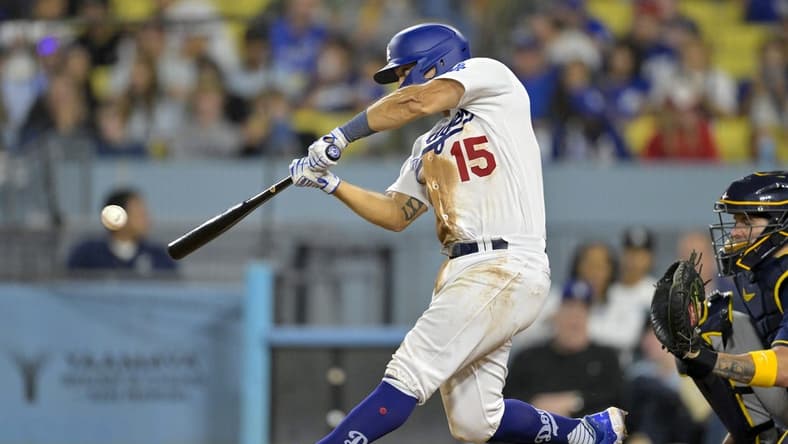 Aug 17, 2023; Los Angeles, California, USA;  Los Angeles Dodgers catcher Austin Barnes (15) hits a solo home run in the eighth inning against the Milwaukee Brewers at Dodger Stadium. Mandatory Credit: Jayne Kamin-Oncea-USA TODAY Sports