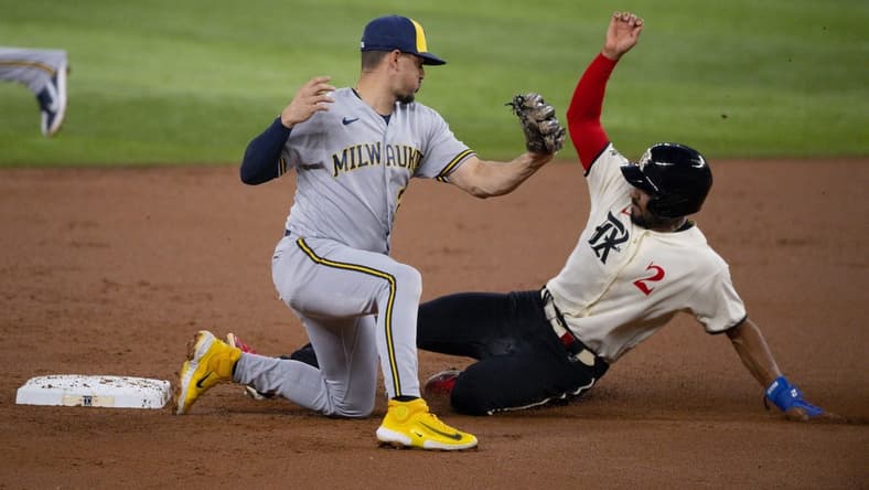 Aug 18, 2023; Arlington, Texas, USA; Texas Rangers second baseman Marcus Semien (2) slides under the tag  of Milwaukee Brewers shortstop Willy Adames (27) as he steals second base during the first inning at Globe Life Field. Mandatory Credit: Jerome Miron-USA TODAY Sports