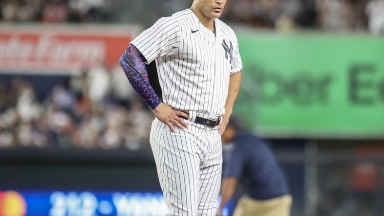 Aug 18, 2023; Bronx, New York, USA; New York Yankees right fielder Giancarlo Stanton (27) stays on the field after an inning ending double play in the sixth inning against the Boston Red Sox at Yankee Stadium. Mandatory Credit: Wendell Cruz-USA TODAY Sports