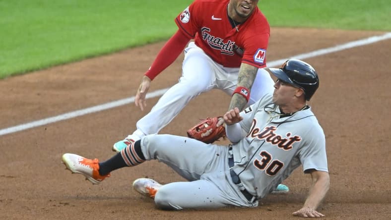 Aug 18, 2023; Cleveland, Ohio, USA; Detroit Tigers right fielder Kerry Carpenter (30) is tagged out by Cleveland Guardians third baseman Gabriel Arias (13) in the second inning at Progressive Field. Mandatory Credit: David Richard-USA TODAY Sports