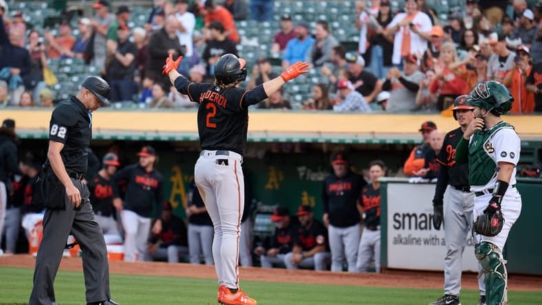 Aug 18, 2023; Oakland, California, USA; Baltimore Orioles infielder Gunnar Henderson (2) jumps onto home plate after hitting a two run home run against the Oakland Athletics during the second inning at Oakland-Alameda County Coliseum. Mandatory Credit: Robert Edwards-USA TODAY Sports