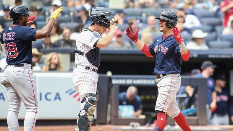 Aug 19, 2023; Bronx, New York, USA;  Boston Red Sox second baseman Luis Urias (right) is greeted by shortstop Pablo Reyes (19) after hitting a grand slam home run in the second inning against the New York Yankees at Yankee Stadium. Mandatory Credit: Wendell Cruz-USA TODAY Sports