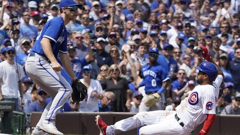 Aug 19, 2023; Chicago, Illinois, USA; Chicago Cubs third baseman Jeimer Candelario (9) is safe at third base with a triple as Kansas City Royals third baseman Matt Duffy (15) waits for  throw during the second inning at Wrigley Field. Mandatory Credit: David Banks-USA TODAY Sports