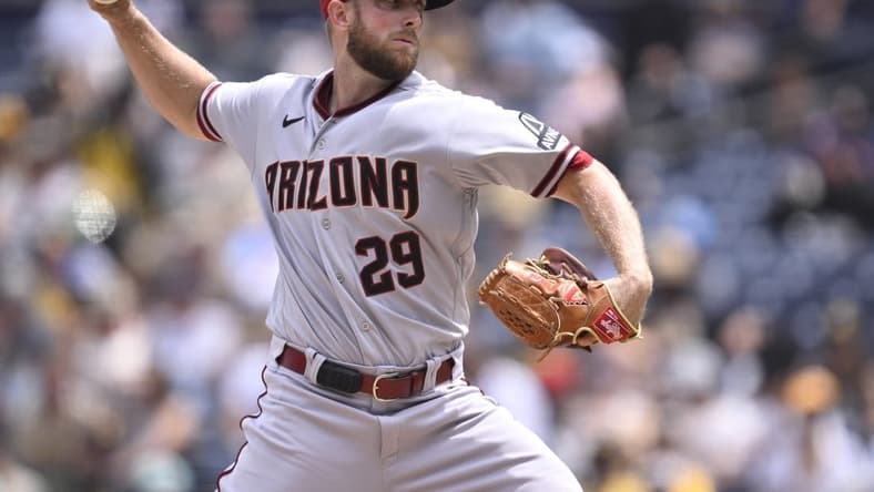 Aug 19, 2023; San Diego, California, USA; Arizona Diamondbacks starting pitcher Merrill Kelly (29) throws a pitch against the San Diego Padres during the first inning at Petco Park. Mandatory Credit: Orlando Ramirez-USA TODAY Sports