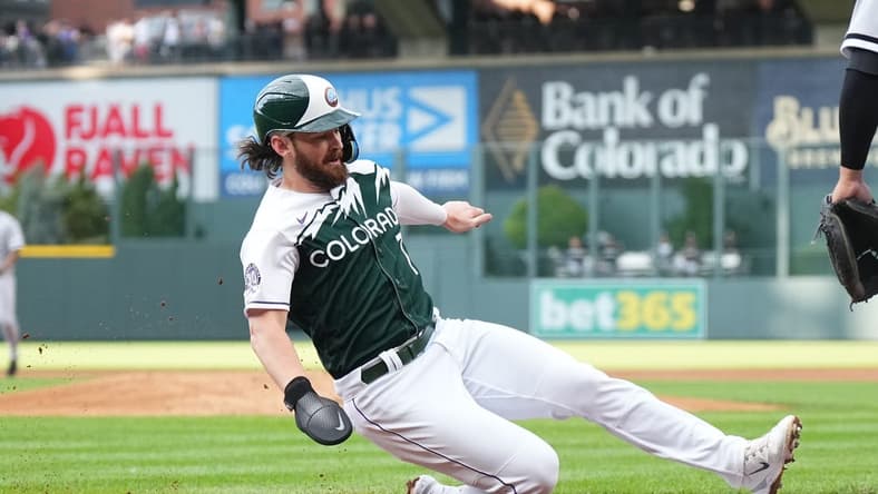 Aug 19, 2023; Denver, Colorado, USA; Colorado Rockies second baseman Brendan Rodgers (7) scores in the first inning against the Chicago White Sox  at Coors Field. Mandatory Credit: Ron Chenoy-USA TODAY Sports