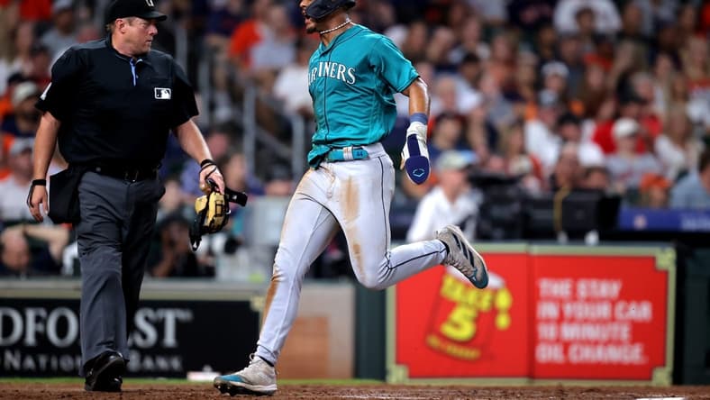 Aug 19, 2023; Houston, Texas, USA; Seattle Mariners center fielder Julio Rodriguez (44) crosses home plate to score a run against the Houston Astros during the eighth inning at Minute Maid Park. Mandatory Credit: Erik Williams-USA TODAY Sports