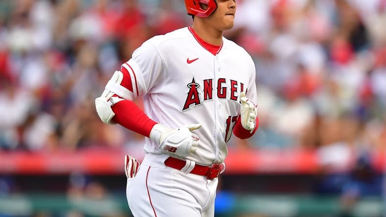 Aug 19, 2023; Anaheim, California, USA; Los Angeles Angels designated hitter Shohei Ohtani (17) returns to the dugout after hitting a pop fly ball during the first inning at Angel Stadium. Mandatory Credit: Gary A. Vasquez-USA TODAY Sports