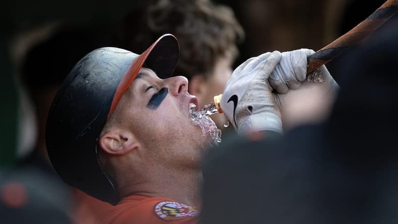 Aug 19, 2023; Oakland, California, USA; Baltimore Orioles catcher James McCann gets a drink from the ceremonial funnel after hitting a home run against the Oakland Athletics during the fourth inning at Oakland-Alameda County Coliseum. Mandatory Credit: D. Ross Cameron-USA TODAY Sports