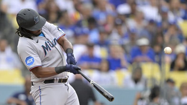 Aug 19, 2023; Los Angeles, California, USA;  Miami Marlins designated hitter Josh Bell (9) hits a solo home run in the first inning against the Los Angeles Dodgers at Dodger Stadium. Mandatory Credit: Jayne Kamin-Oncea-USA TODAY Sports