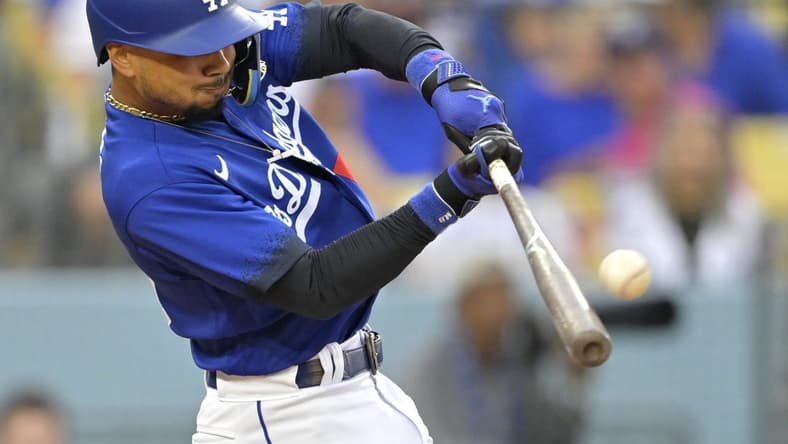 Aug 19, 2023; Los Angeles, California, USA;  Los Angeles Dodgers right fielder Mookie Betts (50) hits a solo home run in the third inning against the Miami Marlins at Dodger Stadium. Mandatory Credit: Jayne Kamin-Oncea-USA TODAY Sports