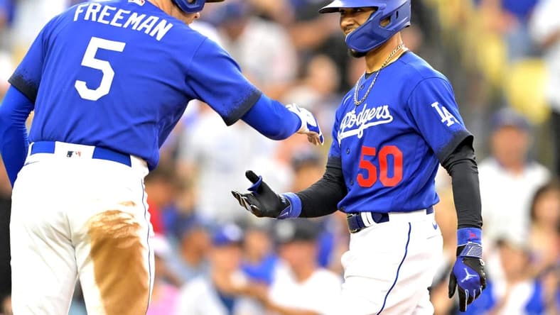 Aug 19, 2023; Los Angeles, California, USA; Los Angeles Dodgers right fielder Mookie Betts (50) is congratulated by first baseman Freddie Freeman (5) after hitting a solo home run in the third inning against the Miami Marlins at Dodger Stadium. Mandatory Credit: Jayne Kamin-Oncea-USA TODAY Sports