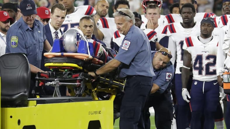 Aug 19, 2023; Green Bay, WI, USA; Teammates look on as New England Patriots cornerback Isaiah Bolden (7) is taken off the field on a stretcher after a fourth quarter injury against the Green Bay Packers during their preseason football game at Lambeau Field. The game was suspended in the fourth quarter after the injury. Mandatory Credit: Dan Powers-USA TODAY Sports