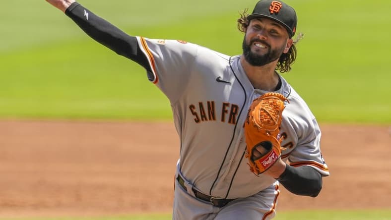 Aug 20, 2023; Cumberland, Georgia, USA; San Francisco Giants pitcher Jakob Junis (34) pitches against the Atlanta Braves during the first inning at Truist Park. Mandatory Credit: Dale Zanine-USA TODAY Sports