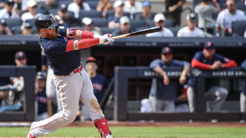 Aug 20, 2023; Bronx, New York, USA; Boston Red Sox first baseman Justin Turner (2) hits a three-run home run in the seventh inning against the New York Yankees at Yankee Stadium. Mandatory Credit: Wendell Cruz-USA TODAY Sports