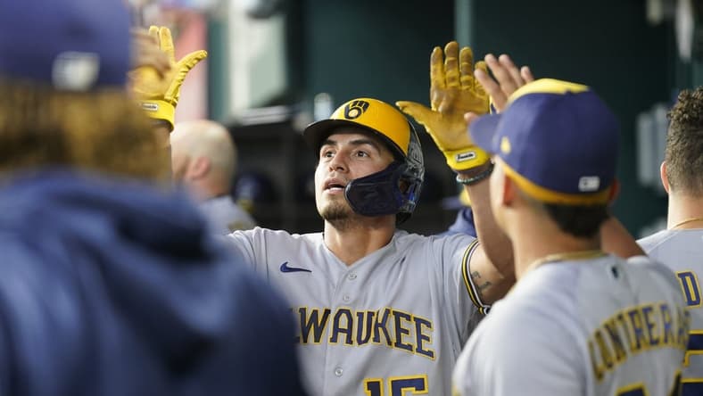 Aug 20, 2023; Arlington, Texas, USA; Milwaukee Brewers right fielder Tyrone Taylor (15) celebrates scoring a run on a double hit by Milwaukee Brewers left fielder Christian Yelich (22) against the Texas Rangers during the fourth inning at Globe Life Field. Mandatory Credit: Jim Cowsert-USA TODAY Sports